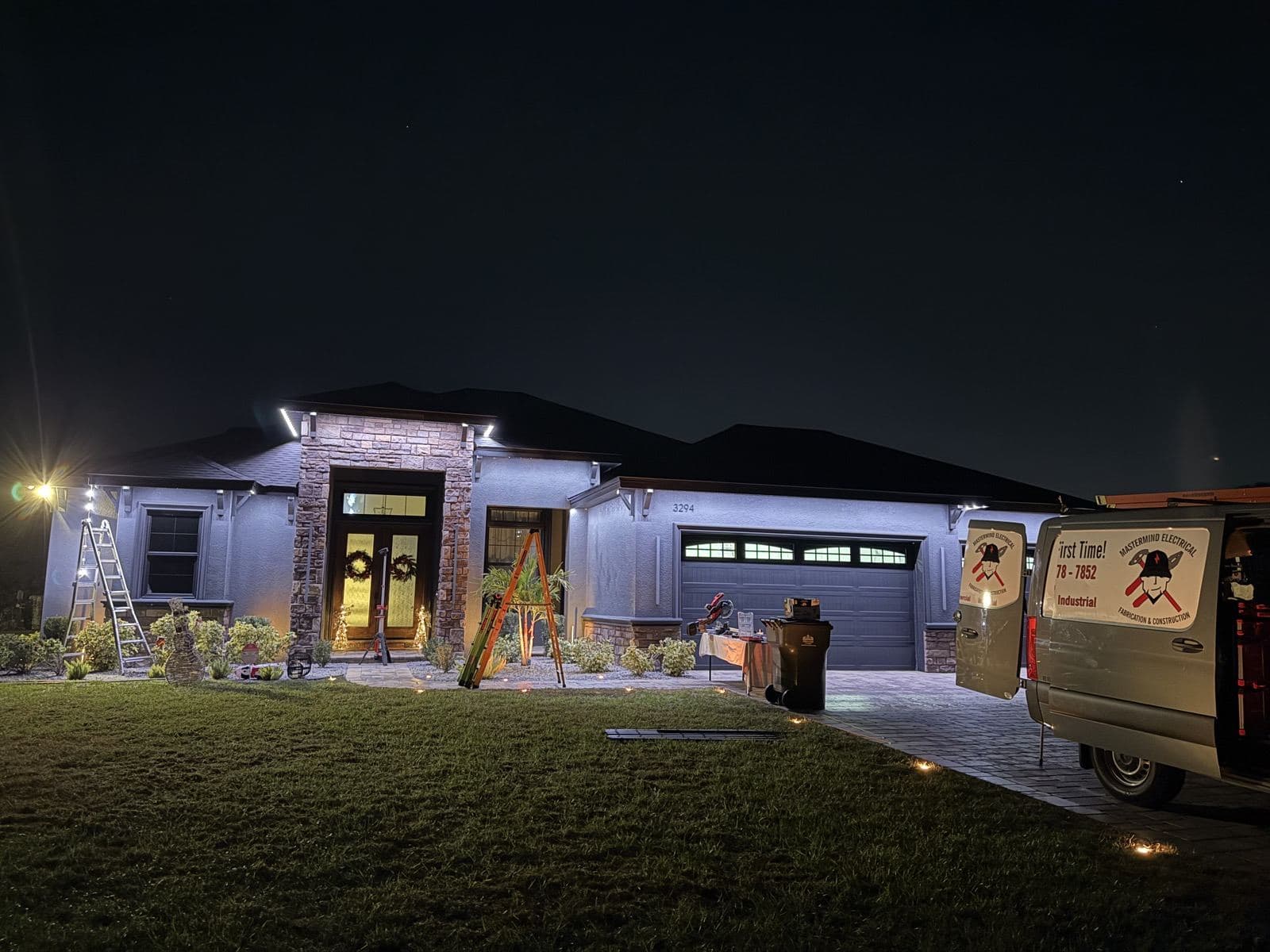 Home at night with roofline lighting and a Mastermind Electrical van out front